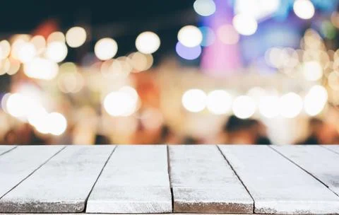 Selective Empty wooden table in front of abstract blurred festive light backg Stock Photos