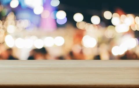 Selective Empty wooden table in front of abstract blurred festive light backg Stock Photos