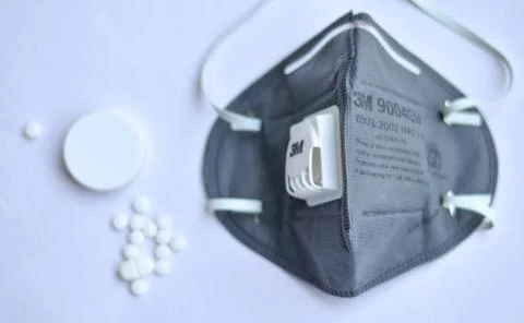 Selective focus of 3M Grey N95 face mask on a white background Stock Photos
