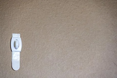 Selective focus on adhesive strip wall hanger that can be removed by pulling Stock Photos