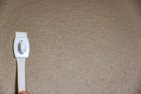 Selective focus on adhesive strip wall hanger that can be removed by pulling Stock Photos