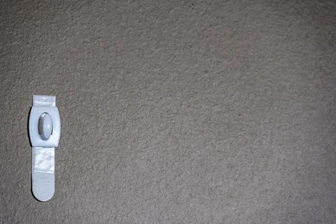 Selective focus on adhesive strip wall hanger that can be removed by pulling Stock Photos