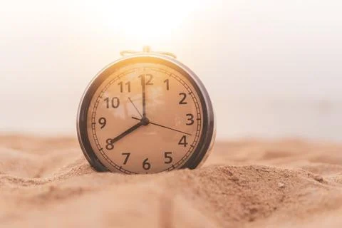 Selective focus of alarm clock with nature background. Stock Photos
