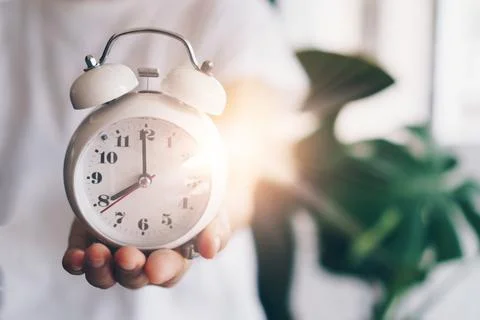 Selective focus of alarm clock with nature bokeh background. lifestyle prod.. Stock Photos