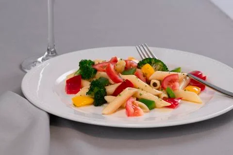 Selective focus and close up of delicious looking pasta and vegetables on a p Stock Photos