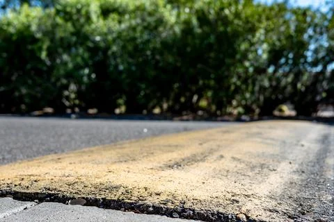 Selective focus on area in front of a asphalt speed bump . Stock Photos