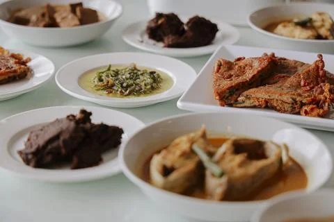 Selective Focus of Authentic Padang Dishes on Dining Table Stock Photos