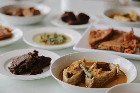 Selective Focus of Authentic Padang Dishes on Dining Table Stock Photos