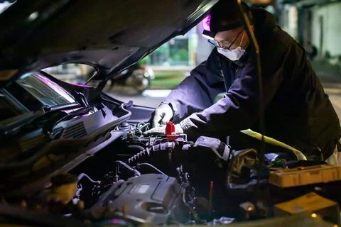 Selective focus to Auto mechanic providing on-site mobile service replacing.. Stock Photos