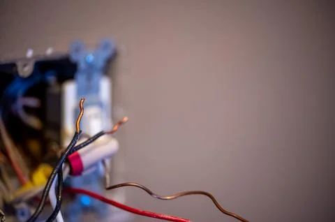 Selective focus on bare wire on an electrical project that is a shock hazard. Stock Photos