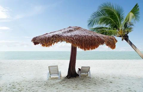 Selective focus beach chairs with umbrella wood and beautiful sand beach with Stock Photos