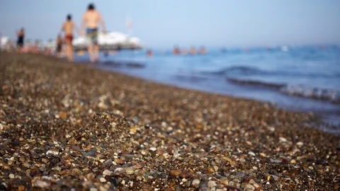 Selective focus. Beach with large sand and waves that run ashore in the defoc 스톡 동영상 92008052