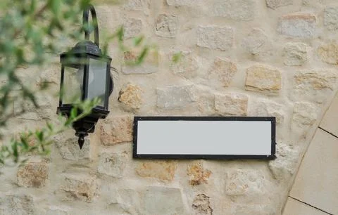 Selective focus of beige brick wall with white empty billboard for writing Stock Photos