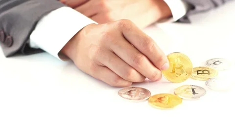 Selective focus at Bitcoin finger play in hand of business man Stock Footage 87773137