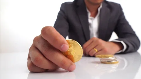 Selective focus at bitcoin in young business man put on tower coin l Stock Footage 88456770