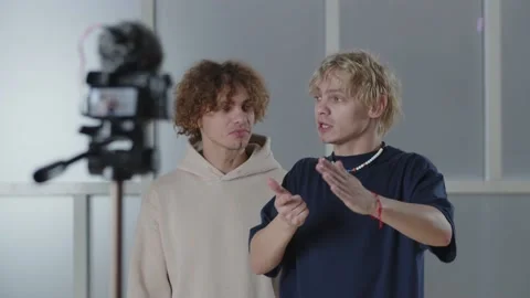 Selective focus of bloggers talking in front of camera. Two content creators Stock Footage 232884522