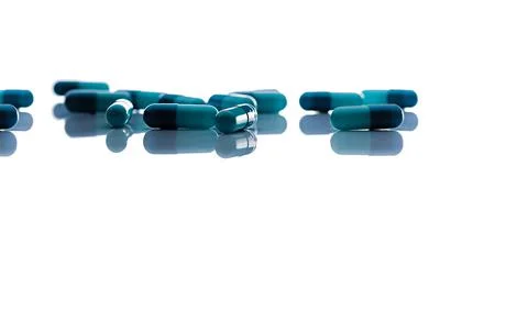 Selective focus on blue capsule pills. Group of capsule pills with shadow spr Stock-Fotos