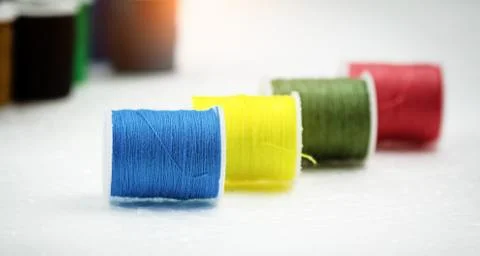 In selective focus of blue color thread,The roll of thread on background,need Stock Photos