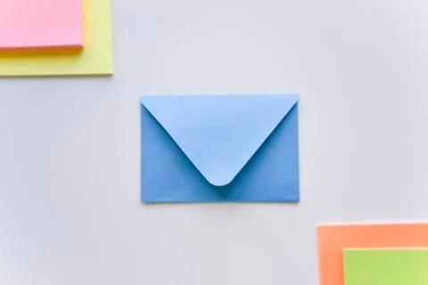 Selective focus, blue envelope in the center with colored rectangles in corne Stock Photos