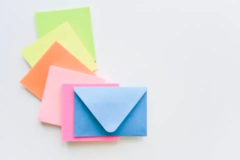 Selective focus, blue envelope in the center with colored rectangles spreadin Stock Photos