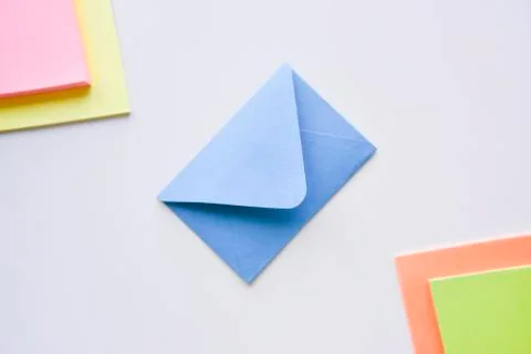 Selective focus, blue envelope in the center with colored rectangles in corne Stock Photos