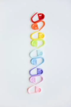 Selective focus with blurry effect at colored safety pins Stock Photos