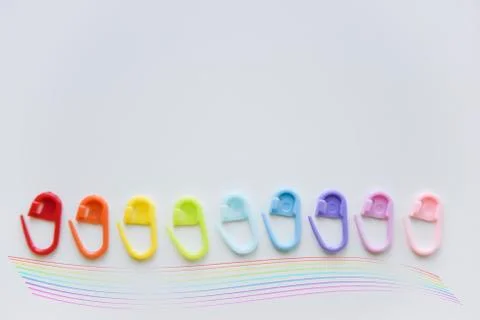 Selective focus with blurry effect at colored safety pins curved with the len Stock Photos