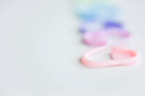 Selective focus with blurry effect at colored safety pins Stock Photos