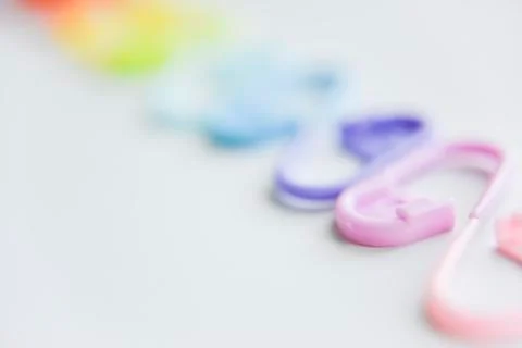 Selective focus with blurry effect at colored safety pins Stock Photos