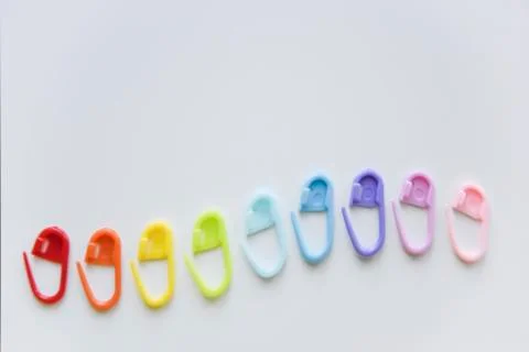 Selective focus with blurry effect at colored safety pins curved with the len Stock Photos