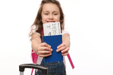 Selective focus on boarding pass, flight ticket in the hands of a blurred cute Stock Photos