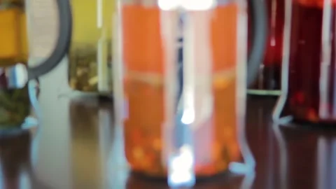 Selective focus from bokeh to focus on a French press with floating herbs. Stock Footage 156378009