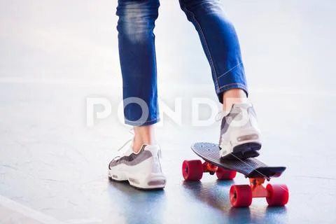 Selective focus to boy skateboarder is skateboarding and riding on street. Stock Photos
