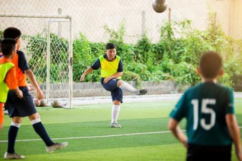 Selective focus to boy soccer player speed run to control and shoot ball to g Stock Photos