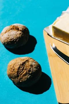 Selective focus of bread and butter, typical French breakfast. On blue backgr Stock Photos