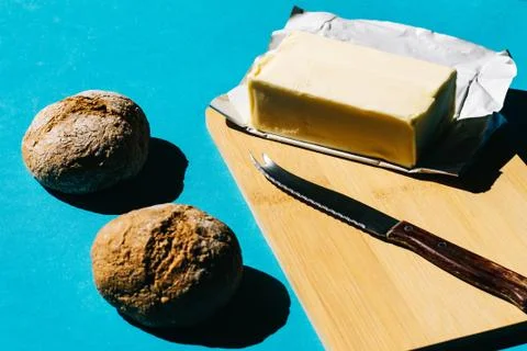 Selective focus of bread and butter, typical French breakfast. On blue backgr Foto stock