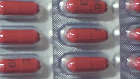 Selective focus. Brown capsules in blister. Blister with medicine. Stockbeeldmateriaal 167658354