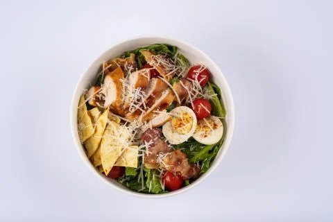 Selective focus Caesar salad with roasted chiken, bacon, quail eggs, lettuce  Stock Photos
