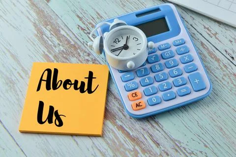 Selective focus of calculator, clock and memo note with text ABOUT US Stock Photos
