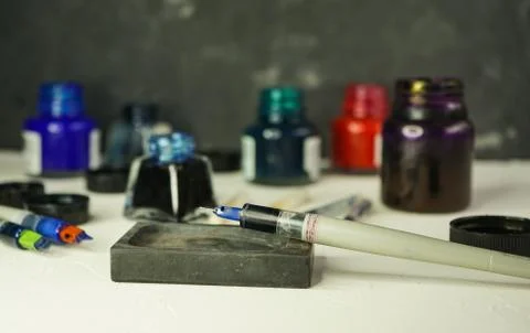 Selective focus, calligraphy set with ink jars and brushes Stock Photos