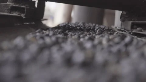 Selective focus, camera follows movement of dry coffee on production mat Stock Footage 163426885