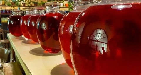 Selective focus. Canned fruit drinks in glass jars. Compote of berries in jars Stock Photos