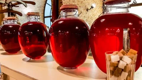 Selective focus. Canned fruit drinks in glass jars. Compote of berries in jars Stock Photos