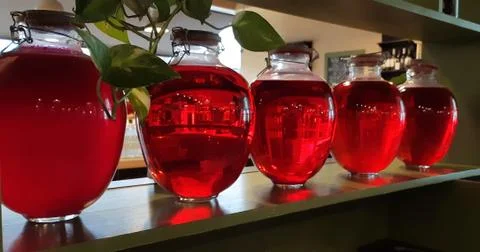 Selective focus. Canned fruit drinks in glass jars. Compote of berries in jars Stock Photos