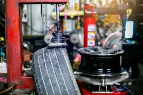 Selective focus to car tire patch machine in car service center. Stock Photos