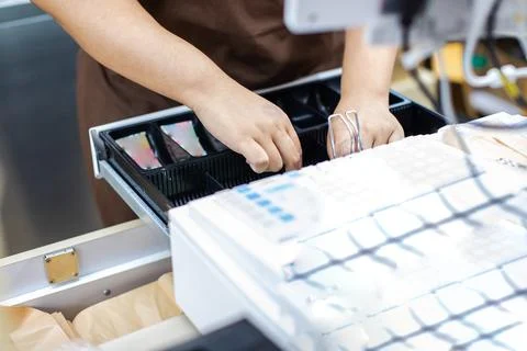 Selective focus to Cashier Hands Opening Cash Register Drawer at Retail Che.. Stock Photos