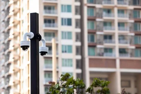 Selective focus to CCTV Camera with blurry building. Stock Photos