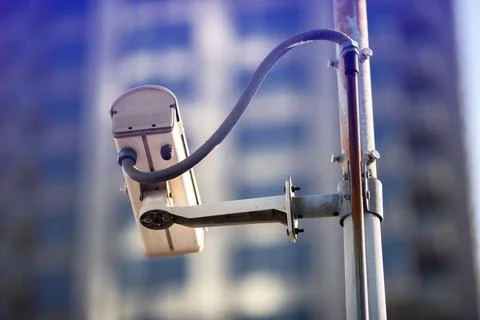 Selective focus to CCTV Camera with blurry building. Stock Photos