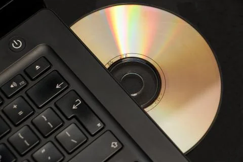 Selective focus cd or dvd in laptop drive Stock Photos