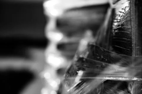 Selective focus on cellophane shrink wrap on pallets of goods for transport. Stock Photos